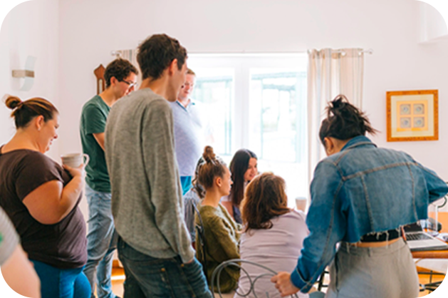 A large, bright room filled with people conversing over drinks