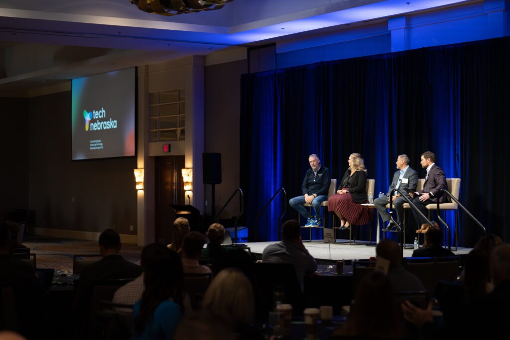 A group of people on stage at the Tech Nebraska Summit