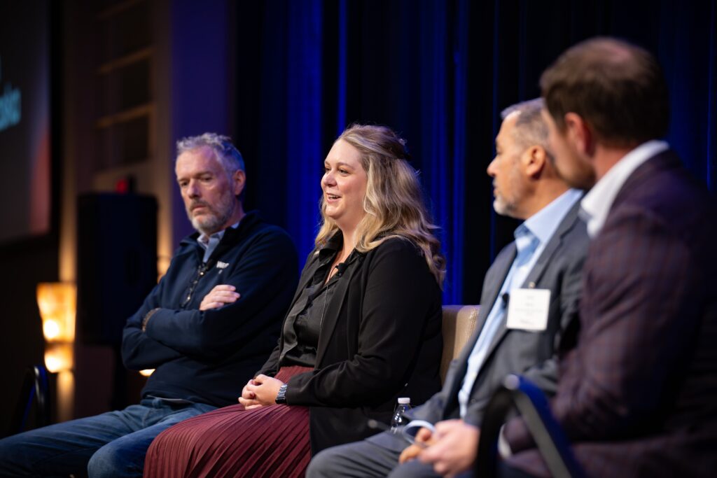 A close-up shot of the panelists listening as Katie Curtis is talking