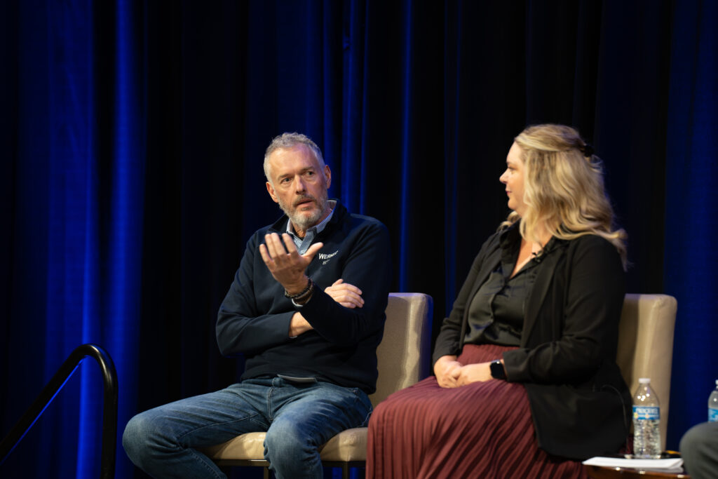 Man and woman sitting on a stage having a conversation