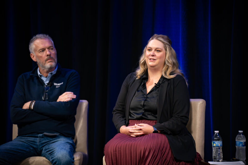 Man and woman sitting on stage